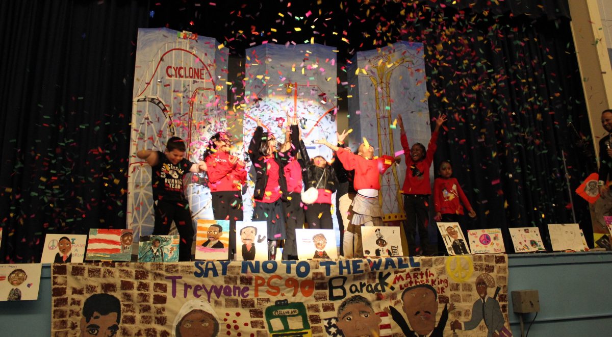 Out of School Time program students celebrate onstage after their Poetry Slam Performance.